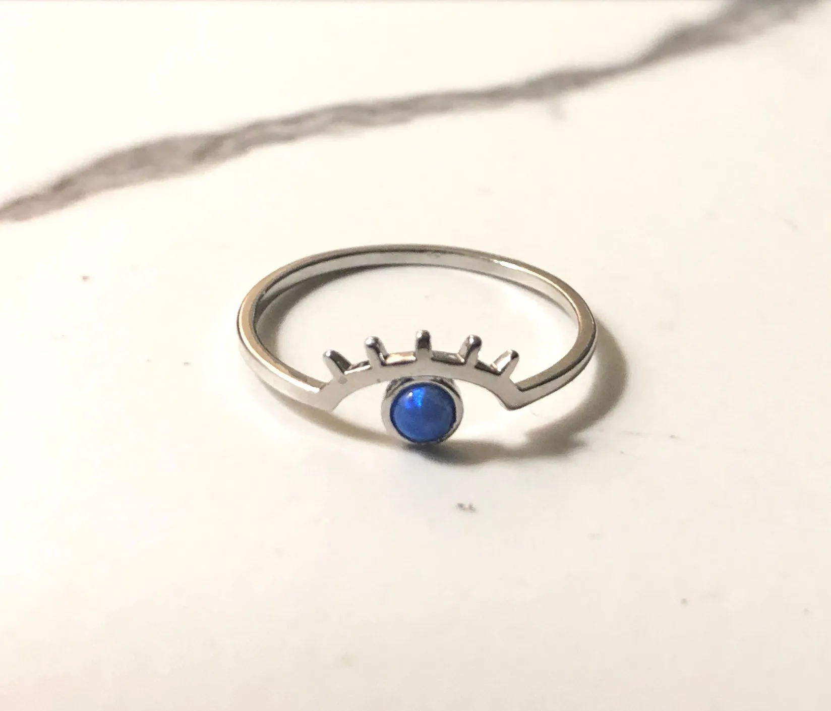 cosmic blue eyed wink ring