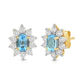 Jewelili 18K Yellow Gold over Sterling Sliver 6x4 MM Oval Genuine Swiss Blue Topaz and 1/20 Cttw Natural White Round Diamond Cluster Stud Earrings