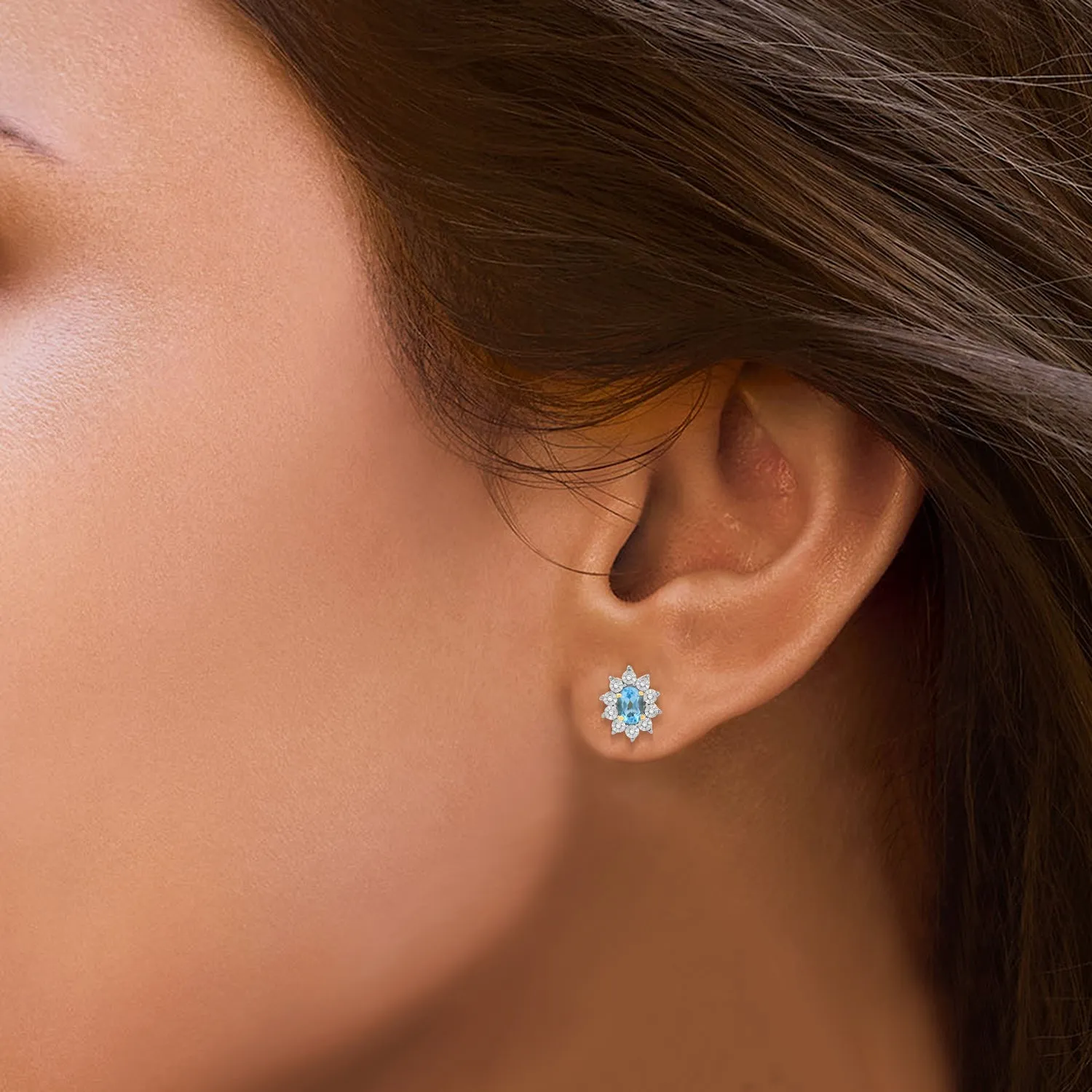 Jewelili 18K Yellow Gold over Sterling Sliver 6x4 MM Oval Genuine Swiss Blue Topaz and 1/20 Cttw Natural White Round Diamond Cluster Stud Earrings
